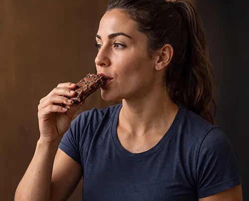 Athlete eating The Complete Protein Bar